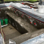 worker pouring concrete for a custom pool foundation by Signature Pools