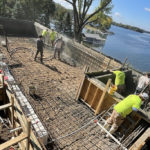 workers spraying concrete for a custom pool foundation by Signature Pools