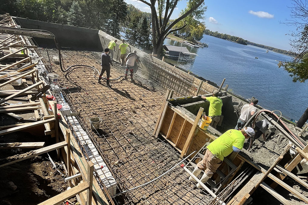workers spraying concrete for a custom pool foundation by Signature Pools