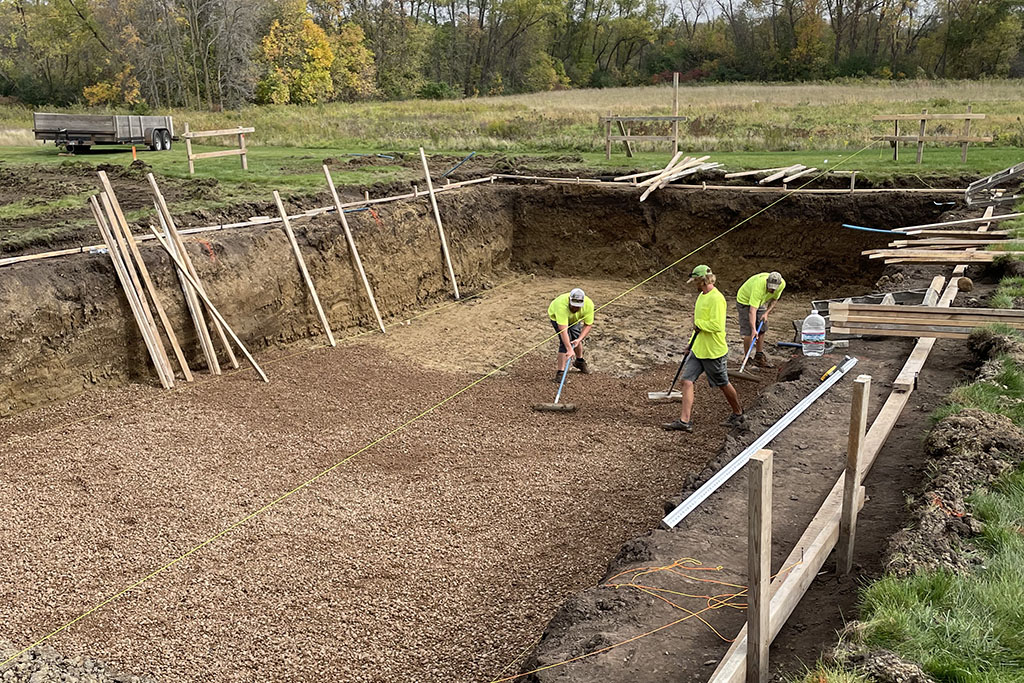 workers excavating a foundation for a custom pool design by Signature Pools